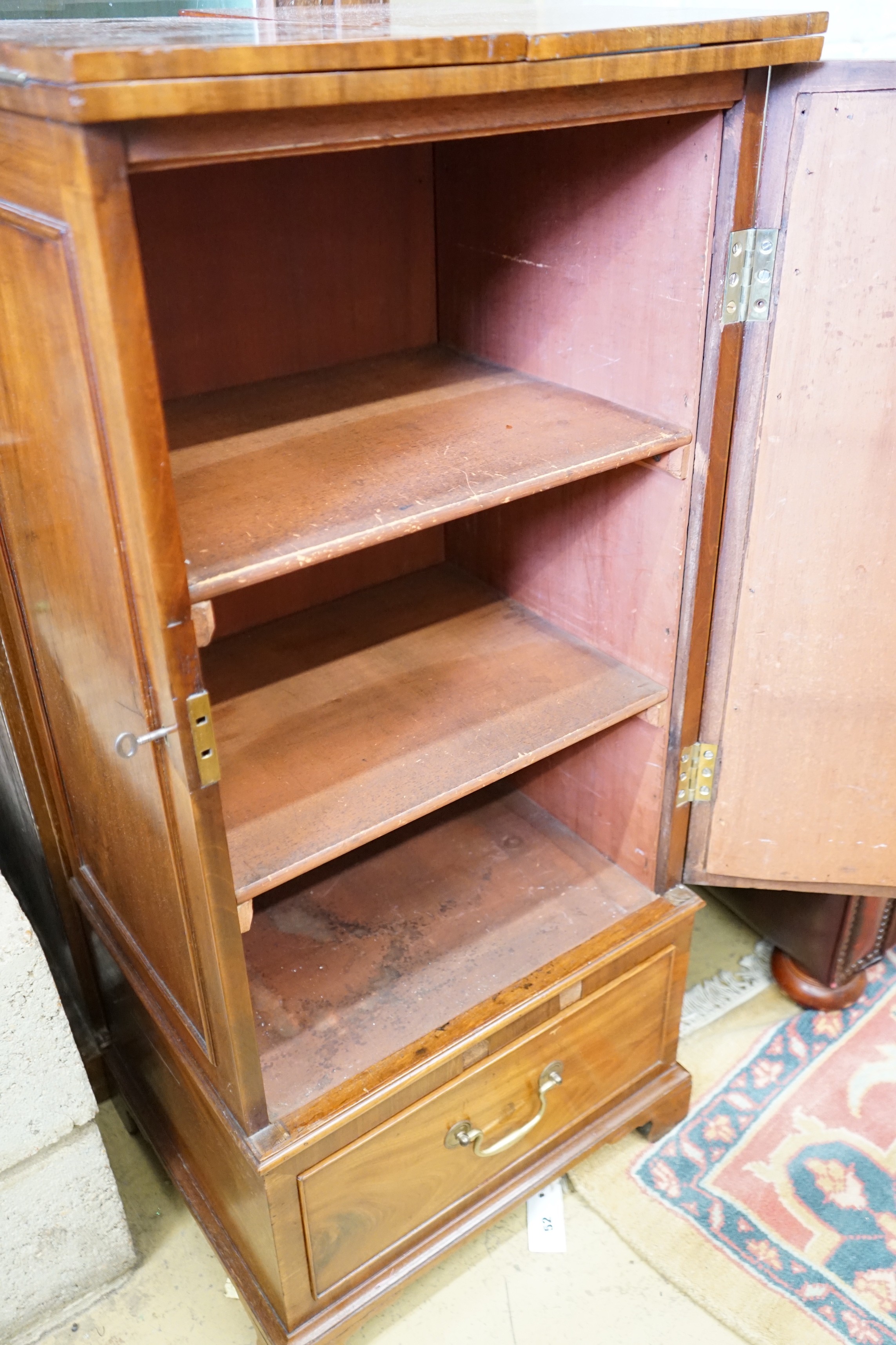 A Georgian style mahogany side cabinet with twin flap top, height 105cm together with a narrow Victorian bookcase, height 189cm